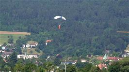 A paraglider comes in for a landing at Grenchen Airfield